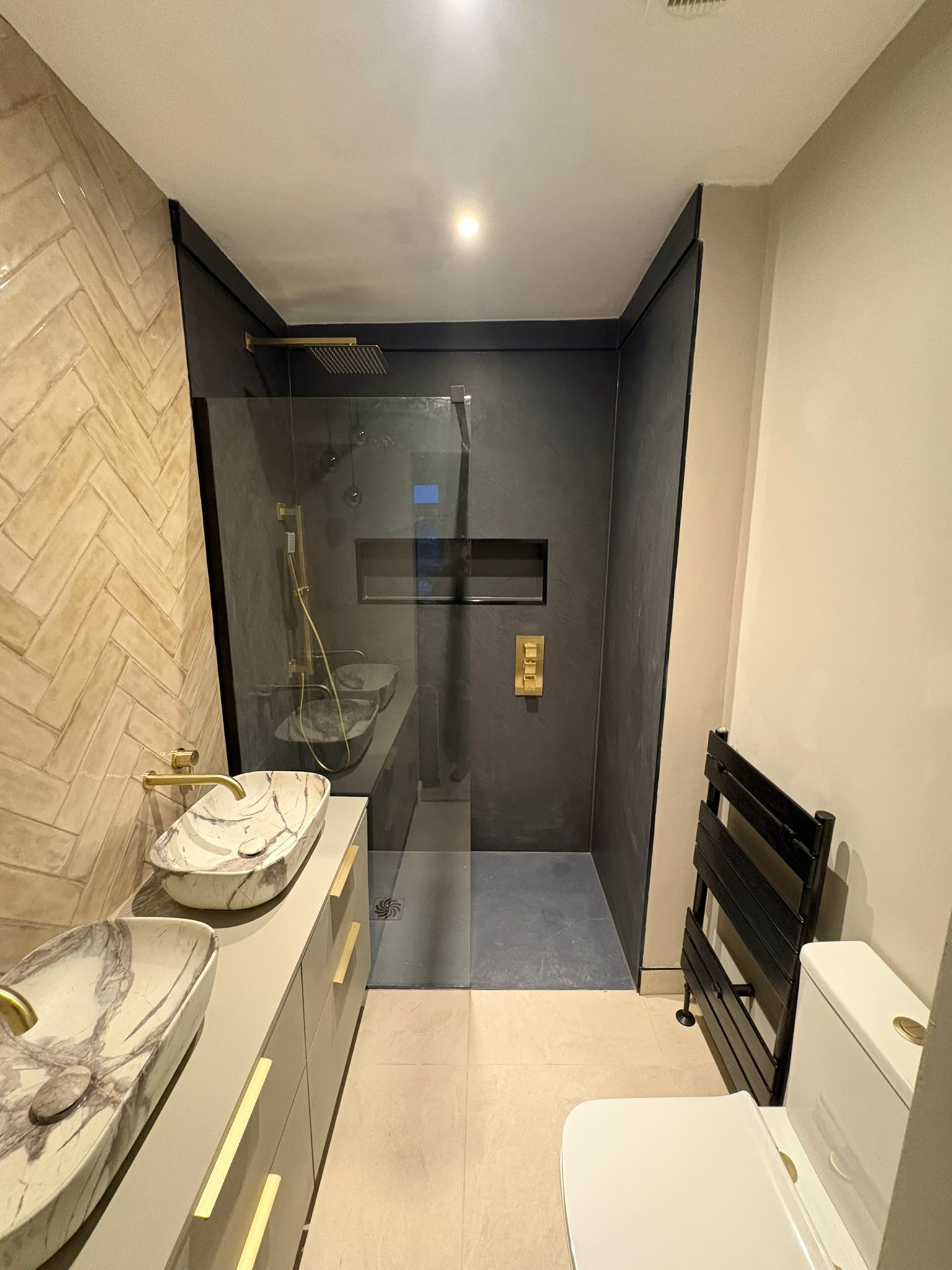 Twin marble vessel basins with walk-in shower