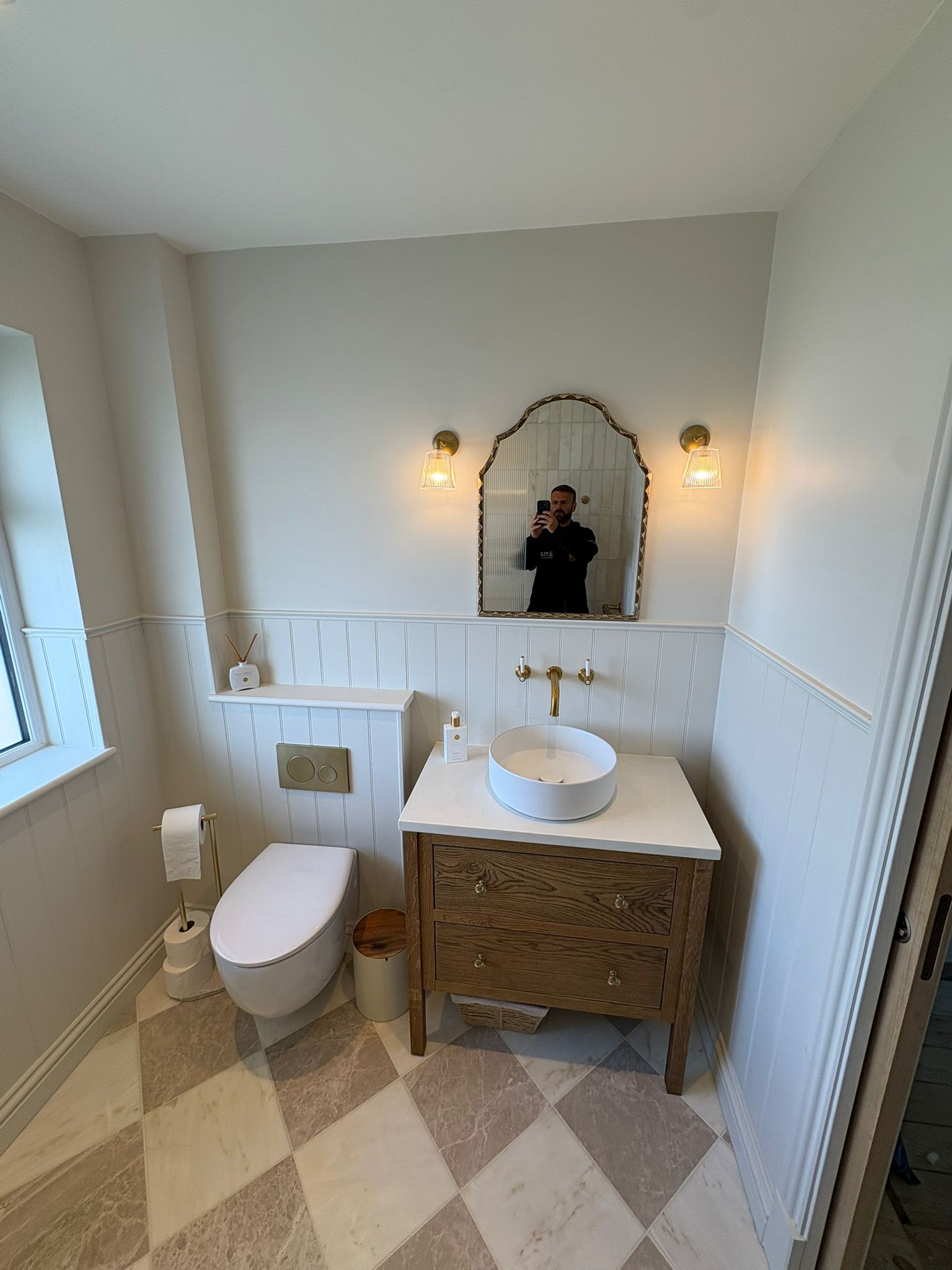 Panelled cloakroom with oak vanity and chequerboard floor