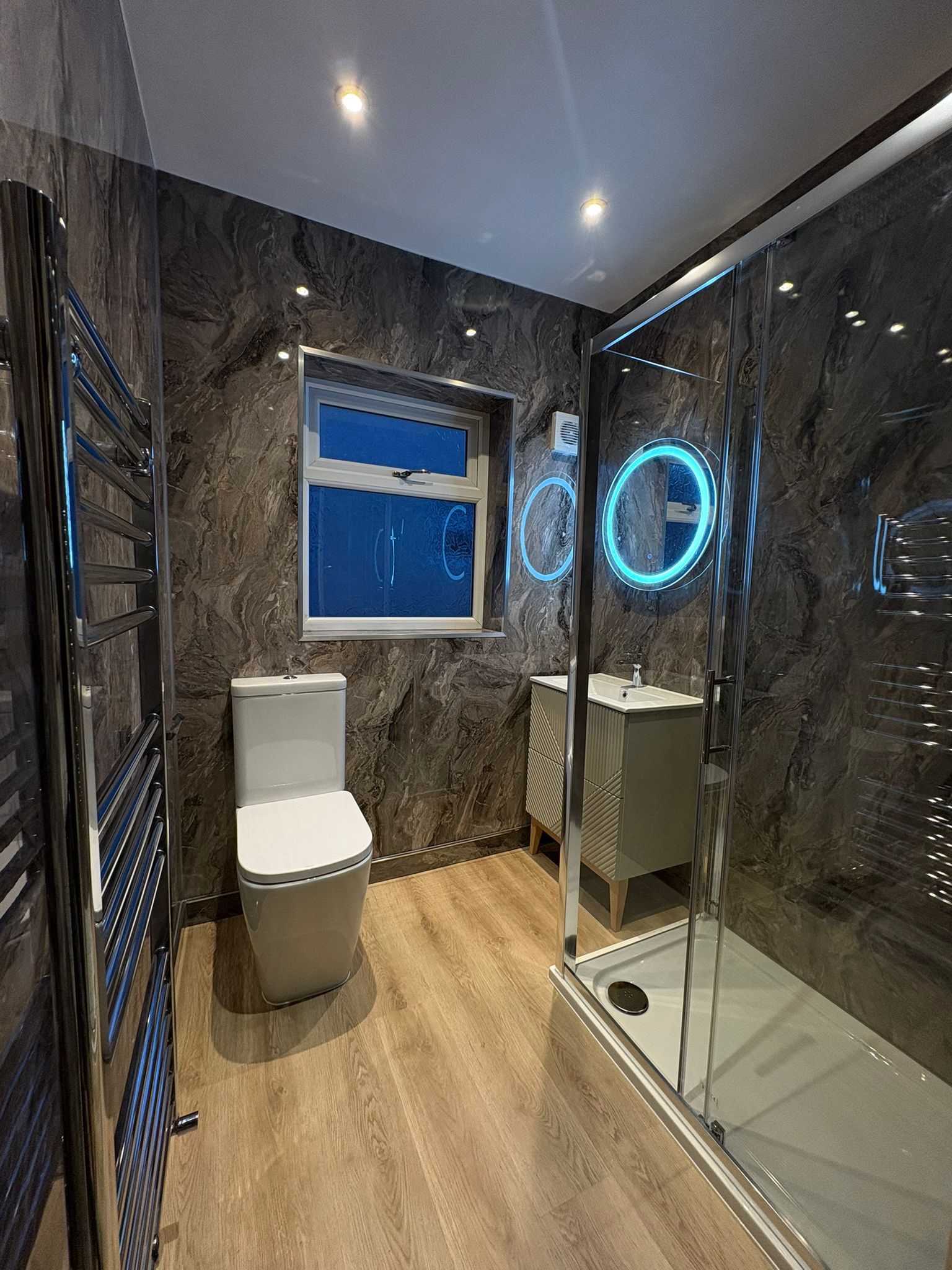 Dark marble bathroom with walk-in shower